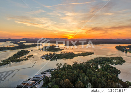 Aerial view of sunset over Wallis Lake in Forster NSW Australia. Drone photograph captures calm waterways, colourful evening sky reflections and the scenic coastal landscape Aerial view of sunset over Wallis Lake in Forster NSW Australia. Drone photograph captures calm waterways, colourful evening sky reflections and the scenic coastal landscape 139716174