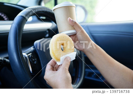 Asian woman driver hold coffee cup for drink in car. Asian woman driver hold coffee cup for drink in car. 139716738