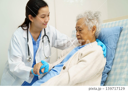 Asian doctor checking and treat elderly woman patient health in hospital. Asian doctor checking and treat elderly woman patient health in hospital. 139717129
