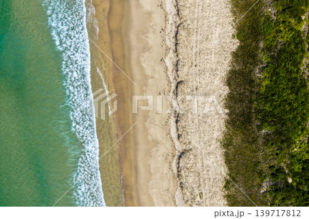 Aerial view of Nine Mile Beach in Tuncurry NSW Australia. Drone photograph captures the expansive sandy shoreline, rolling ocean waves and scenic coastal landscape 139717812
