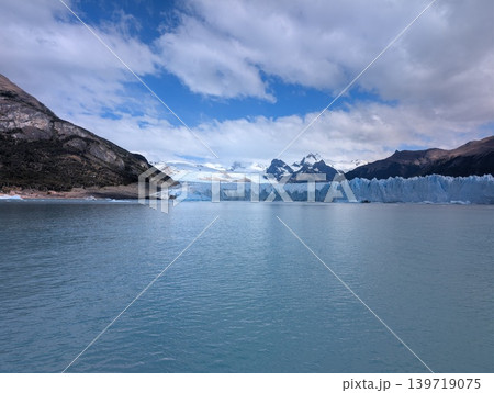Wide landscape of Argentino Lake with distant glacier and mountains under cloudy sky 139719075
