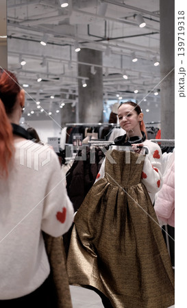 Two teenage friends are shopping for warm winter clothes. Two teenage friends are shopping for warm winter clothes. 139719318