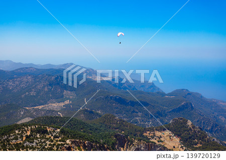 Flying paraglider at Babadag mountain in Turkey Flying paraglider at Babadag mountain in Turkey 139720129