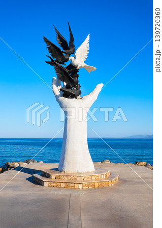Birds in hand statue at Kusadasi seafront promenade in Turkey 139720360