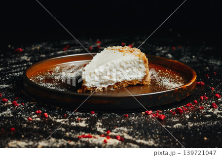Delicious cheesecake slice with crumbly crust 139721047