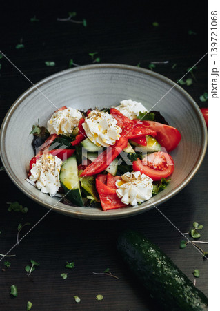 Colorful, fresh salad in a rustic bowl, featuring ripe tomatoes Colorful, fresh salad in a rustic bowl, featuring ripe tomatoes 139721068