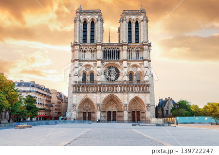 Majestic Notre-Dame de Paris main entrance at sunset, dramatic storm clouds Majestic Notre-Dame de Paris main entrance at sunset, dramatic storm clouds 139722247