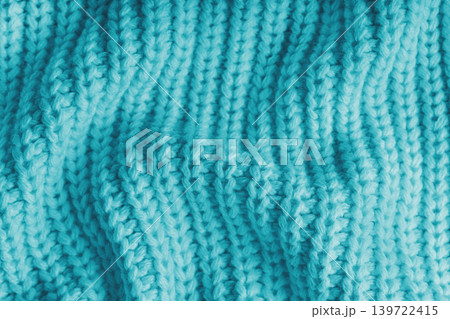 Crumpled turquoise knitted fabric texture with folds, wrinkles and soft waves, wool background 139722415