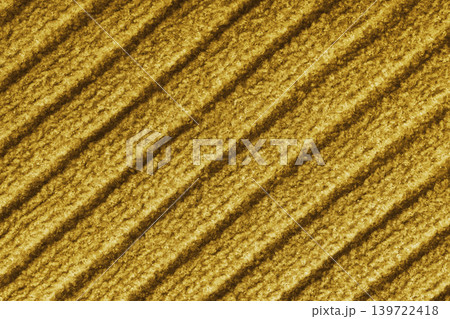 Yellow colored knitted fabric, knitwear texture with diagonal soft ribbed pattern background Yellow colored knitted fabric, knitwear texture with diagonal soft ribbed pattern background 139722418