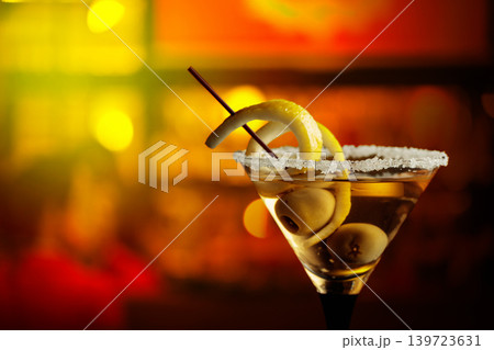 Glass of Martini with green olives and lemon peel. 139723631