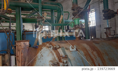 Industrial Boiler Room Interior with Rusty Tank and Green Pipes Industrial Boiler Room Interior with Rusty Tank and Green Pipes 139723669