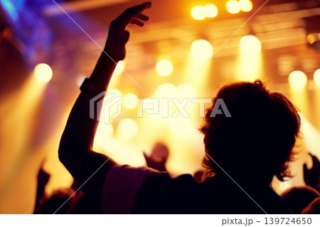 Night, club and man dance at concert, event or music festival with stage lights and silhouette. Dark, nightclub and person in audience, crowd and social celebration at techno rave with energy Night, club and man dance at concert, event or music festival with stage lights and silhouette. Dark, nightclub and person in audience, crowd and social celebration at techno rave with energy 139724650