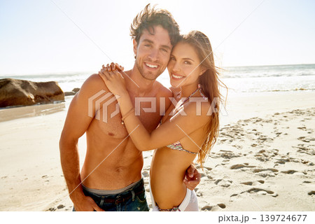 Portrait, love and happy couple hug at a beach for travel, vacation and bonding in nature together. Ocean, adventure and people at sea with care, trust and support, smile and summer body confidence 139724677