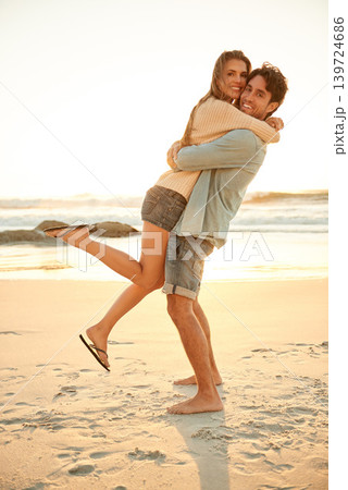 Smile, hug and portrait of couple at beach on vacation, adventure or holiday for valentines day. Sunset, love and man carry, embrace and bond with woman by ocean for weekend trip on romantic date. Smile, hug and portrait of couple at beach on vacation, adventure or holiday for valentines day. Sunset, love and man carry, embrace and bond with woman by ocean for weekend trip on romantic date. 139724686