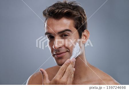 Portrait, shave cream and man with skincare, cosmetics and beauty on a grey studio background. Face, person and model with grooming routine and treatment with beard and moisture with wellness Portrait, shave cream and man with skincare, cosmetics and beauty on a grey studio background. Face, person and model with grooming routine and treatment with beard and moisture with wellness 139724698