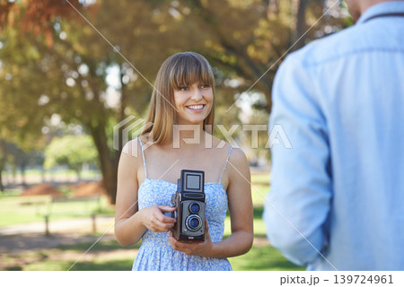 Couple, park or happy woman with vintage camera for outdoor photography, photo memory or tourism. Retro equipment, creative photoshoot or photographer shooting boyfriend for garden picture in nature Couple, park or happy woman with vintage camera for outdoor photography, photo memory or tourism. Retro equipment, creative photoshoot or photographer shooting boyfriend for garden picture in nature 139724961