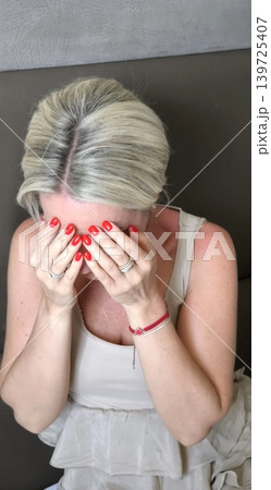 Upset woman covers her face with her hands Upset woman covers her face with her hands 139725407