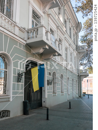 Ukrainian flag hanging on historic building facade Ukrainian flag hanging on historic building facade 139725424