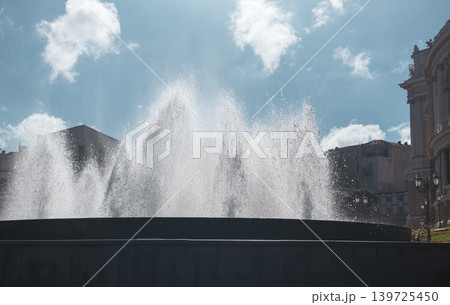 Urban City Fountain with Water Jets and Blue Sky Urban City Fountain with Water Jets and Blue Sky 139725450
