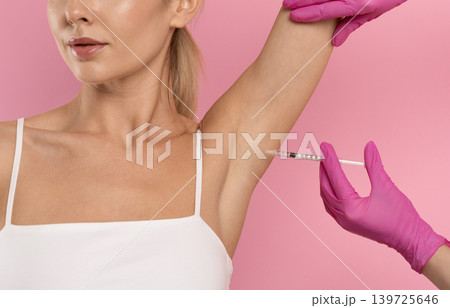 Young woman receiving underarm cosmetic injection treatment for beauty and skincare Young woman receiving underarm cosmetic injection treatment for beauty and skincare 139725646