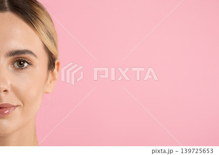 Half face closeup portrait of beautiful young woman with radiant skin Half face closeup portrait of beautiful young woman with radiant skin 139725653