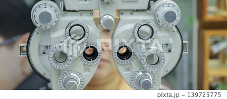 Phoropter for eye test, lenses glasses for eye check in optical store.  139725775