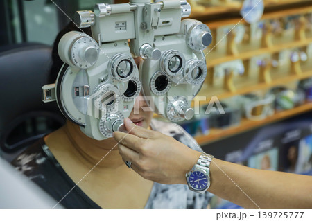 Phoropter for eye test, lenses glasses for eye check in optical store. Phoropter for eye test, lenses glasses for eye check in optical store. 139725777