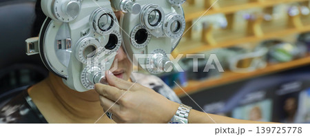 Phoropter for eye test, lenses glasses for eye check in optical store.  139725778