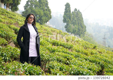 Stylish Indian Woman in Winter Fashion Posing in Lush Green Darjeeling Tea Garden 139726042