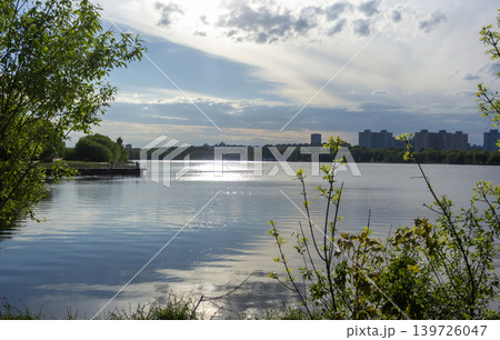 Beautiful lake on a warm day with a view of the city Beautiful lake on a warm day with a view of the city 139726047