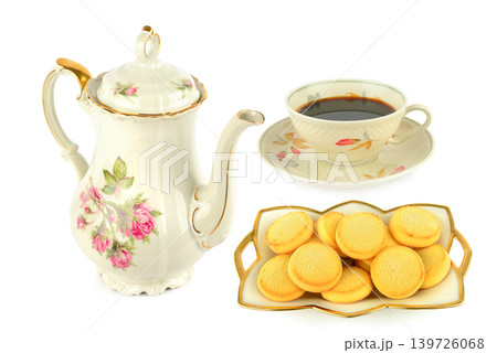 Vintage porcelain tea set with fresh biscuits on a white background. Vintage porcelain tea set with fresh biscuits on a white background. 139726068