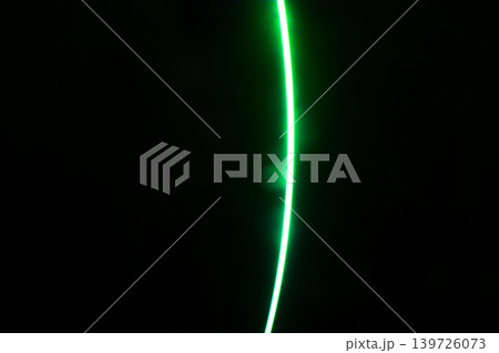 Bright green neon line against dark background with abstract, background 139726073