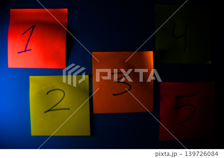 Five colorful sticky notes numbered 1 to 5 on a blue background with sticky note Five colorful sticky notes numbered 1 to 5 on a blue background with sticky note 139726084
