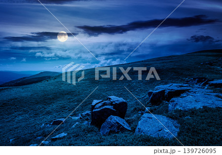 mountain landscape with alpine meadow in mysterious light at night. full moon over carpathian mountain scenery in summer. view in to the distant valley landscape. rolling hills and grassy meadow mountain landscape with alpine meadow in mysterious light at night. full moon over carpathian mountain scenery in summer. view in to the distant valley landscape. rolling hills and grassy meadow 139726095