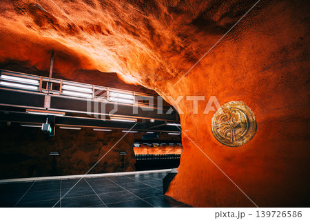 Orange rock cave tunnel with golden ornament at Ostermalmstorg metro station Orange rock cave tunnel with golden ornament at Ostermalmstorg metro station 139726586