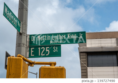 New york, usa august 18,2024. Street signs for martin luther king jr boulevard, madison avenue, and e 125th street intersecting in harlem, new york city New york, usa august 18,2024. Street signs for martin luther king jr boulevard, madison avenue, and e 125th street intersecting in harlem, new york city 139727490
