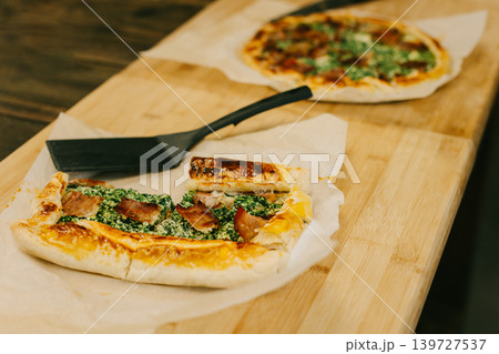 Traditional Italian pie with cheese and ham on a table in a kitchen. Traditional Italian pie with cheese and ham on a table in a kitchen. 139727537