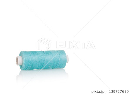 a skein of threads of blue color macro on a white background close up 139727659