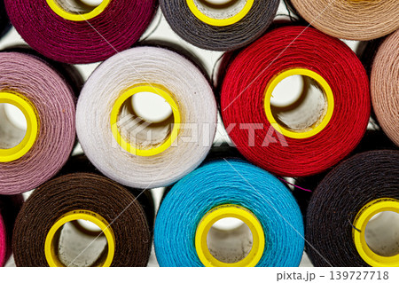 set of multi-colored spools of thread for sewing 139727718