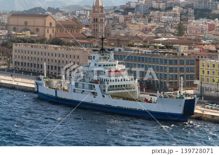 Ferry moored in Messina harbor with cathedral tower and cityscape. Messina, Sicily, Italy Ferry moored in Messina harbor with cathedral tower and cityscape. Messina, Sicily, Italy 139728071