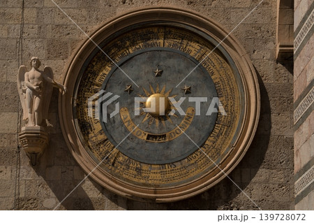 Historic astronomical clock on the stone wall of Messina Cathedral bell tower in Sicily, Italy Historic astronomical clock on the stone wall of Messina Cathedral bell tower in Sicily, Italy 139728072