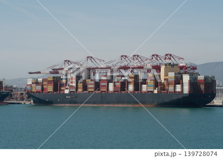 Large container ship at terminal with red gantry cranes Large container ship at terminal with red gantry cranes 139728074