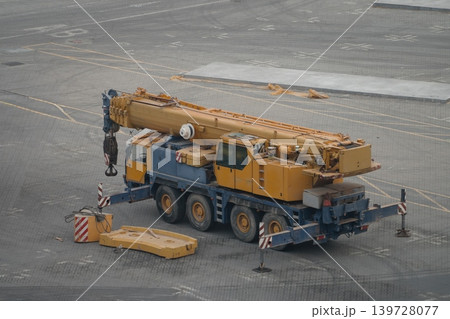 Mobile telescopic crane on four axle chassis at industrial yard Mobile telescopic crane on four axle chassis at industrial yard 139728077