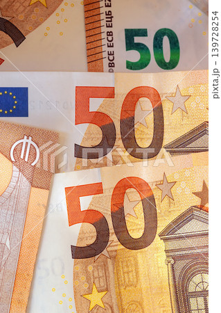 50 euro bills. Close up of euro banknotes with 50 denomination, security patterns, stars, architectural motifs on paper currency. Concept of euro banknotes for finance, banking, payment, savings 139728254