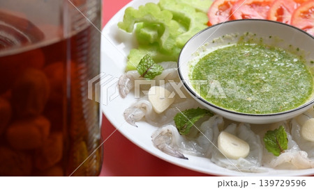 shrimp in fish sauce with Thai spicy seafood dipping sauce on white plate and umeshu shrimp in fish sauce with Thai spicy seafood dipping sauce on white plate and umeshu 139729596