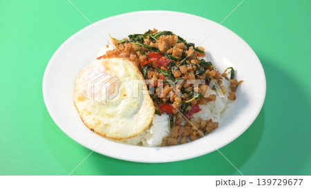 stir fried pork with holy basil on top with fried egg on cooked rice stir fried pork with holy basil on top with fried egg on cooked rice 139729677
