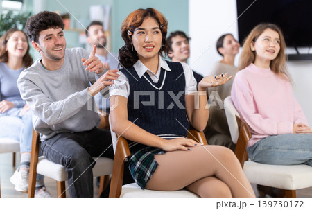 Classmates listening and talking during group discussion in class Classmates listening and talking during group discussion in class 139730172