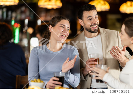 Man flirting with woman, they smile at each other 139730191