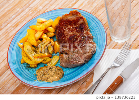 Grilled beef tenderloin steak and fried potato with sauce Grilled beef tenderloin steak and fried potato with sauce 139730223