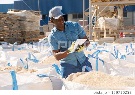Manager keeps records of sandbags in the open area of hardware store 139730252